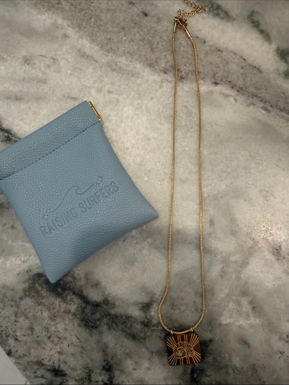 Raising Surfers Gold Pendant Necklace with Light Blue Pouch